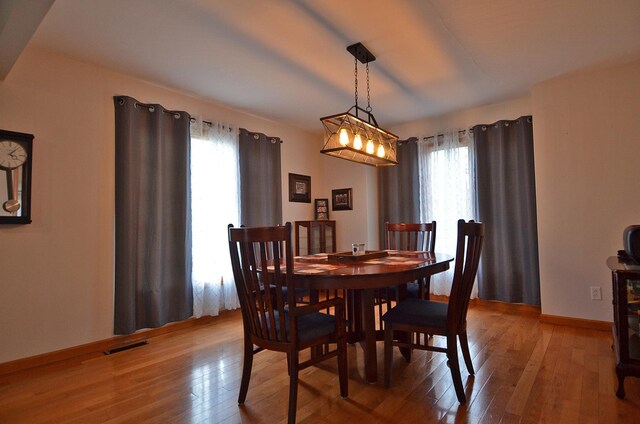 dining room featuring light wood-style flooring and baseboards