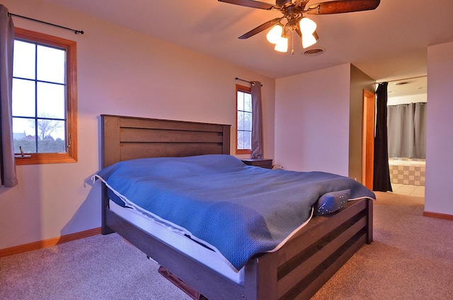 bedroom featuring carpet flooring, baseboards, ceiling fan, and ensuite bath