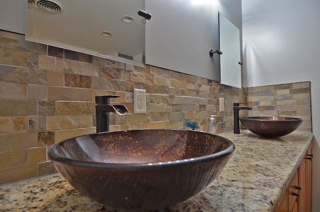 bathroom with tasteful backsplash, double vanity, and a wood stove