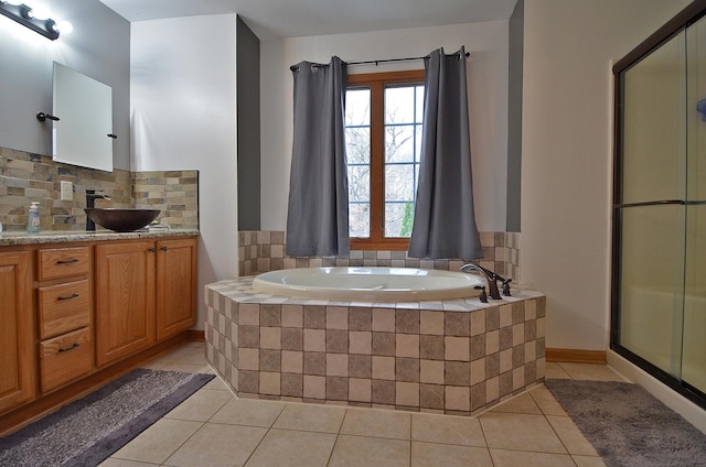 full bath featuring tile patterned flooring, a garden tub, tasteful backsplash, a stall shower, and vanity
