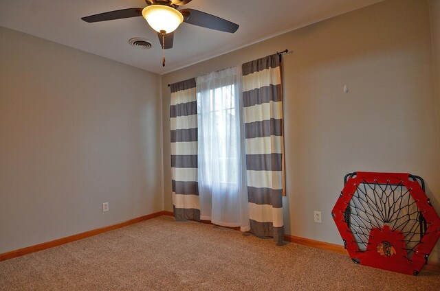unfurnished room with light carpet, a ceiling fan, and baseboards