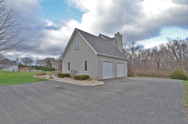 view of home's exterior with asphalt driveway, a chimney, a garage, and a shingled roof