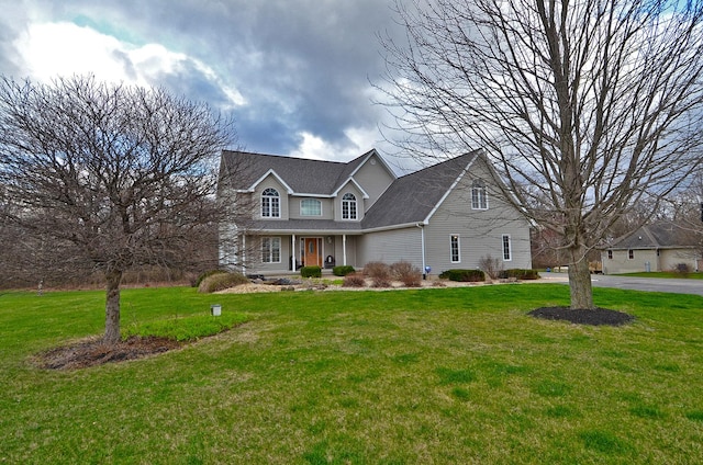 traditional home with a front lawn and covered porch