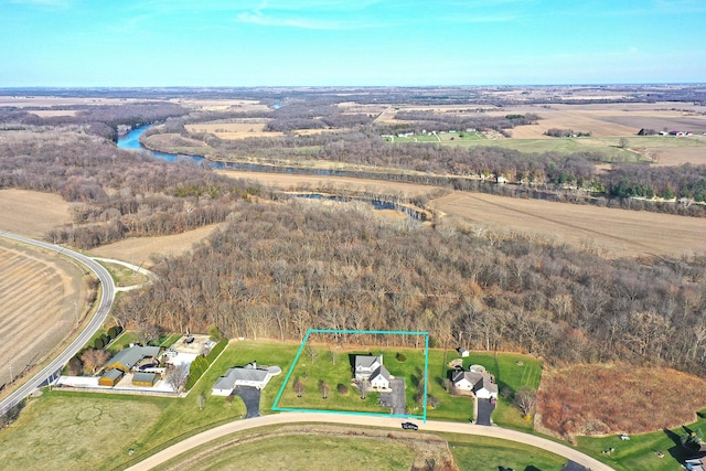 overview of rural landscape with property parcel outlined, a nearby body of water, and a heavily wooded area