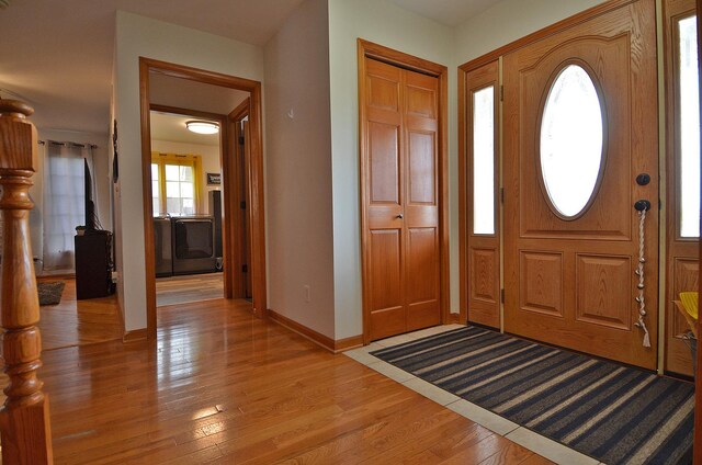 entrance foyer with light wood-style floors and baseboards