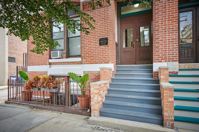 213 W Wisconsin St, Chicago, IL 60614 - doorway to property featuring brick siding, french doors, and cooling unit