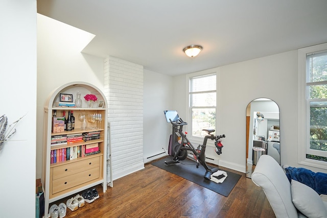 213 W Wisconsin St, Chicago, IL 60614 - workout room featuring dark wood-type flooring, a baseboard radiator, baseboards, and arched walkways