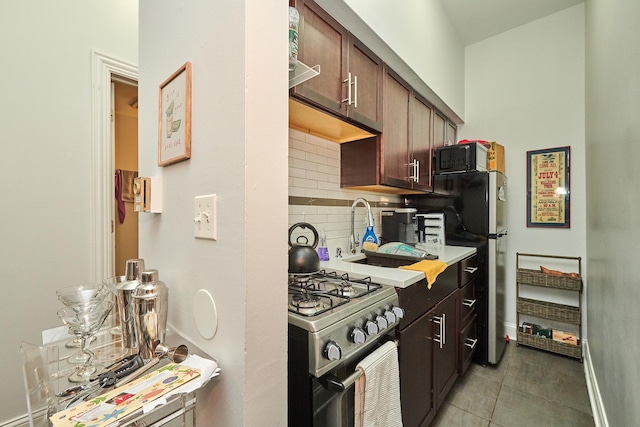 213 W Wisconsin St, Chicago, IL 60614 - kitchen with stainless steel appliances, backsplash, light countertops, dark brown cabinetry, and a sink