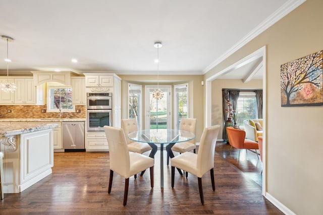 dining area featuring a chandelier, dark wood finished floors, crown molding, recessed lighting, and baseboards