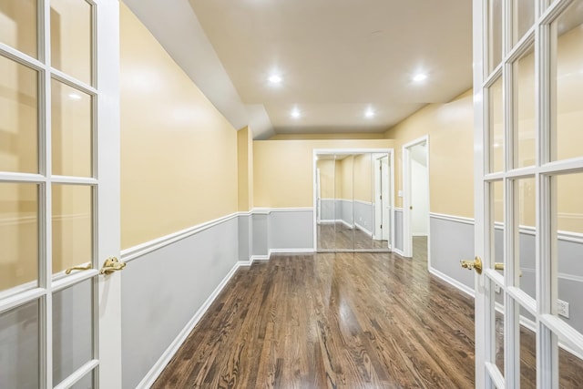 hallway with wood finished floors, lofted ceiling, french doors, recessed lighting, and baseboards