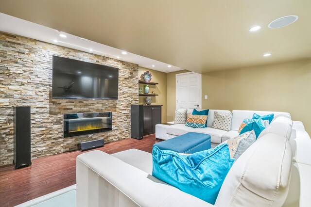 living room featuring dark wood-style floors, recessed lighting, and a glass covered fireplace