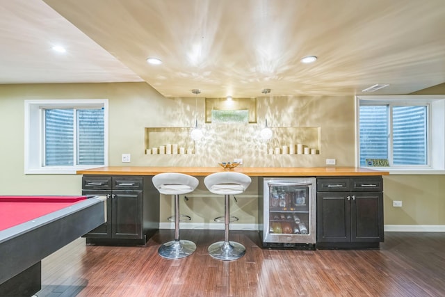 indoor dry bar with wine cooler, dark wood-style flooring, baseboards, recessed lighting, and pool table