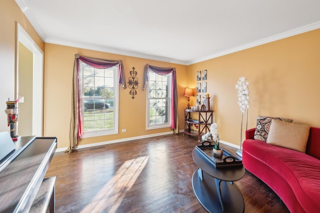 living area with baseboards, crown molding, and wood finished floors