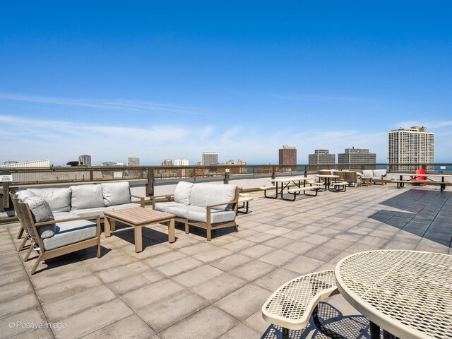 view of patio / terrace with outdoor lounge area and a city view