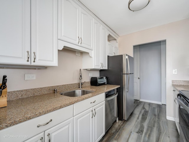 kitchen featuring a sink, stainless steel appliances, white cabinets, and dark wood-style floors