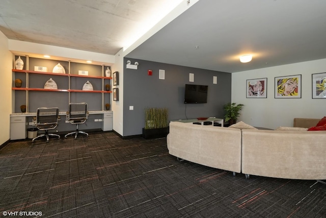 living area with dark carpet