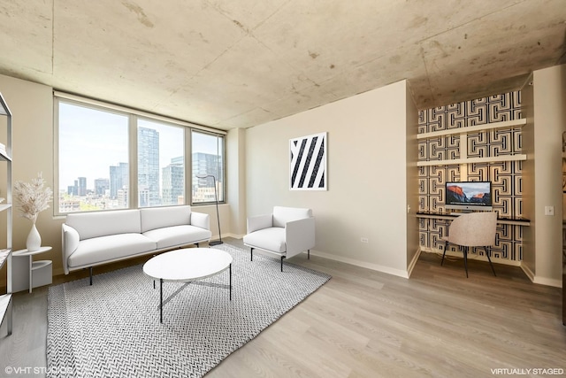 living room featuring wood finished floors, baseboards, and a view of city