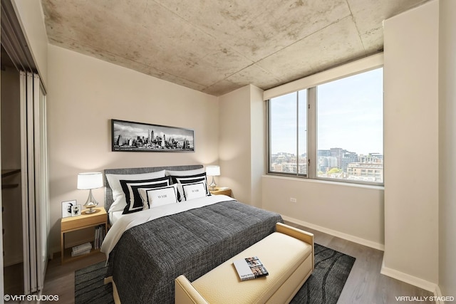 bedroom featuring wood finished floors and baseboards