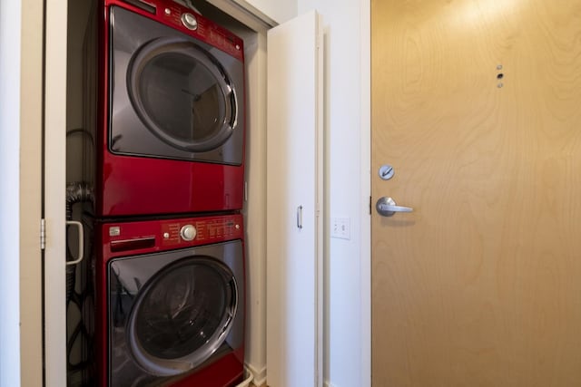 laundry area featuring stacked washer / drying machine