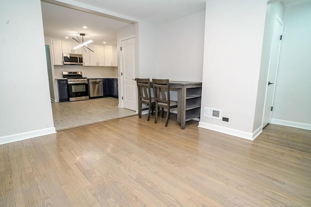 9539 S Forest Ave, Chicago, IL 60628 - dining space with light wood finished floors, baseboards, and recessed lighting