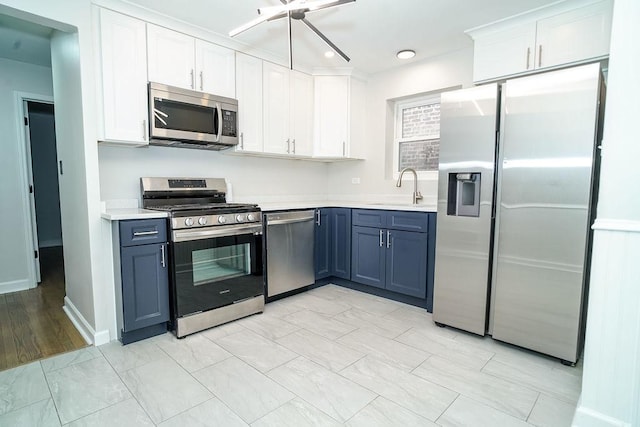 9539 S Forest Ave, Chicago, IL 60628 - kitchen with stainless steel appliances, a sink, light countertops, white cabinets, and recessed lighting