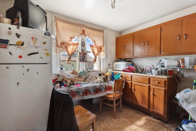 1443 W 49th Pl, Chicago, IL 60609 - kitchen featuring white appliances, brown cabinetry, a sink, and light flooring
