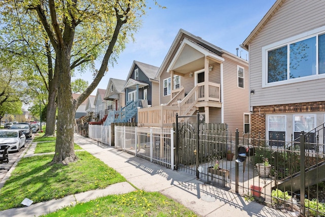 1443 W 49th Pl, Chicago, IL 60609 - view of front facade featuring a fenced front yard, a residential view, a gate, and brick siding