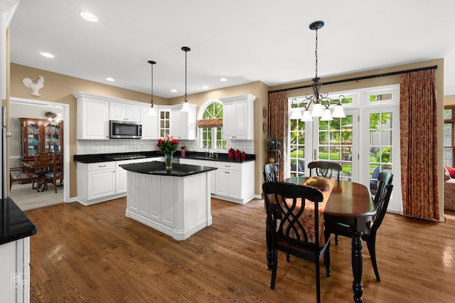 2708 Chittenden Ct, Naperville, IL 60564 - kitchen featuring stainless steel microwave, a center island, stovetop, white cabinets, and recessed lighting