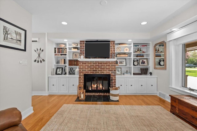 208 N Pkwy, Prospect Heights, IL 60070 - living area featuring a brick fireplace, light wood-style flooring, baseboards, built in shelves, and recessed lighting