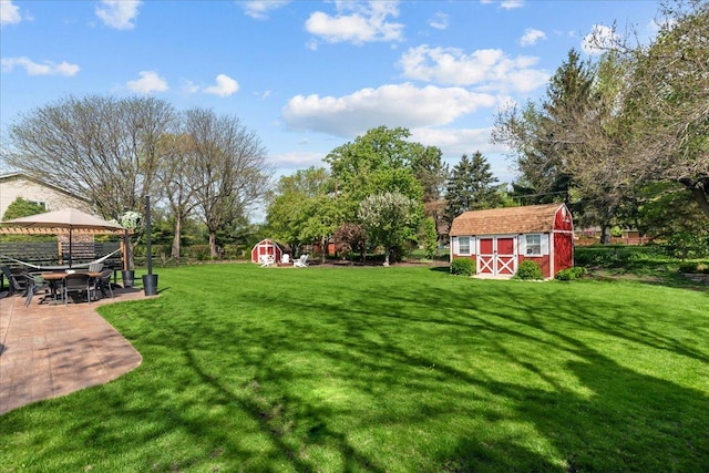 208 N Pkwy, Prospect Heights, IL 60070 - view of yard featuring a shed, an outbuilding, and a patio area