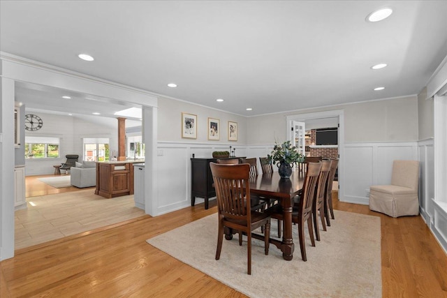 208 N Pkwy, Prospect Heights, IL 60070 - dining room featuring ornate columns, a decorative wall, crown molding, recessed lighting, and light wood-style flooring
