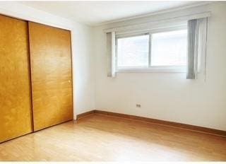 135 S Kenilworth Ave Unit 8, Oak Park, IL 60302 - unfurnished bedroom featuring wood finished floors, a closet, and baseboards