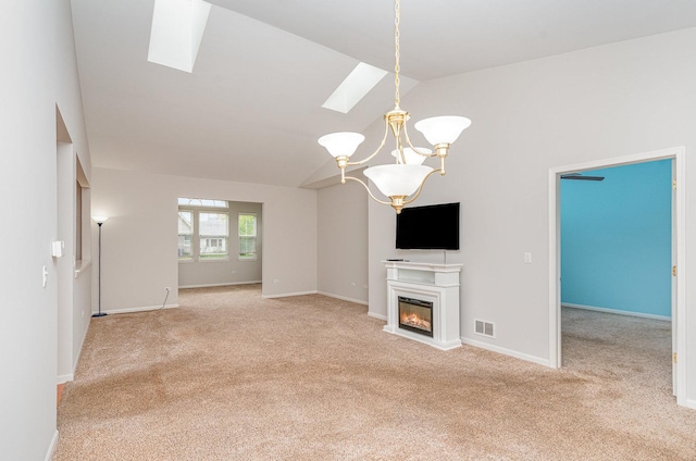 21508 Lake St Clair Dr Unit 0, Crest Hill, IL 60403 - unfurnished living room featuring a skylight, carpet flooring, a chandelier, a glass covered fireplace, and baseboards