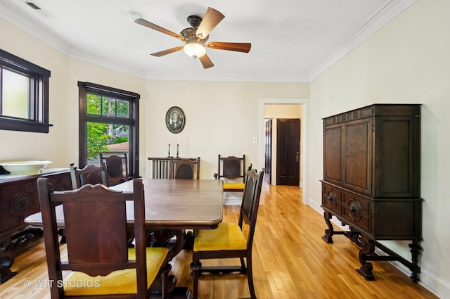 2950 W Wilson Ave, Chicago, IL 60625 - dining room with light wood-style flooring, a ceiling fan, crown molding, and baseboards