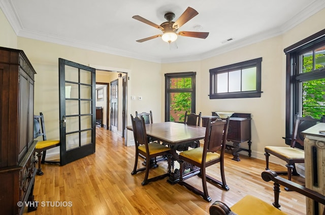 2950 W Wilson Ave, Chicago, IL 60625 - dining space with light wood-type flooring, a ceiling fan, crown molding, and baseboards
