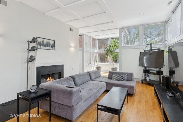 1534 W Henderson St, Chicago, IL 60657 - living area featuring a lit fireplace, coffered ceiling, light wood-type flooring, baseboards, and recessed lighting