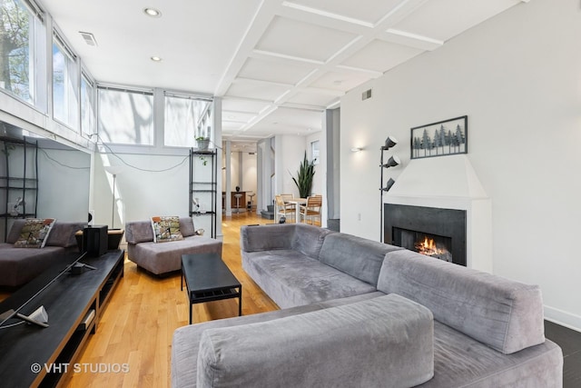 1534 W Henderson St, Chicago, IL 60657 - living area with light wood-style floors, plenty of natural light, a warm lit fireplace, coffered ceiling, and recessed lighting