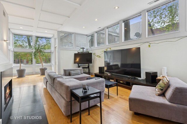 1534 W Henderson St, Chicago, IL 60657 - living room featuring plenty of natural light, recessed lighting, wood finished floors, and a glass covered fireplace