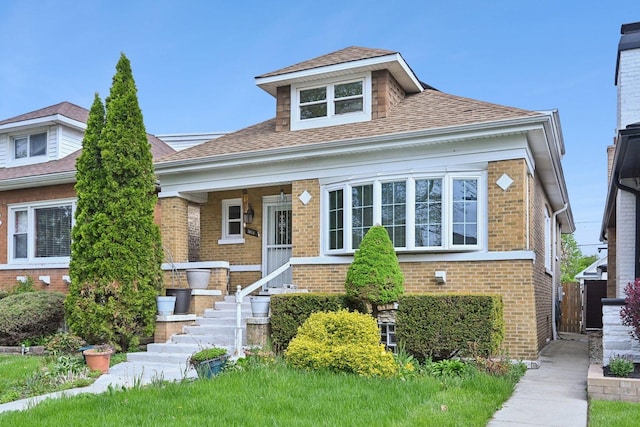 5814 W Roscoe St, Chicago, IL 60634 - bungalow-style house featuring brick siding and roof with shingles
