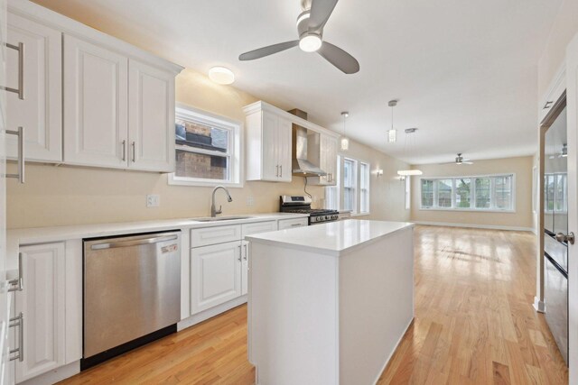 5814 W Roscoe St, Chicago, IL 60634 - kitchen featuring stainless steel appliances, a ceiling fan, a sink, and white cabinetry