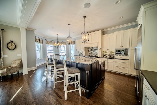75 N Lake Ave, Third Lake, IL 60030 - kitchen featuring ornamental molding, a chandelier, stainless steel microwave, a breakfast bar, and dark wood-style floors
