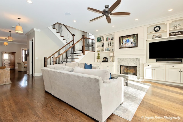 75 N Lake Ave, Third Lake, IL 60030 - living area featuring crown molding, ceiling fan, stairs, wood finished floors, and built in shelves