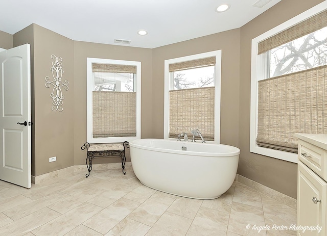 75 N Lake Ave, Third Lake, IL 60030 - full bathroom featuring healthy amount of natural light, a soaking tub, recessed lighting, and baseboards
