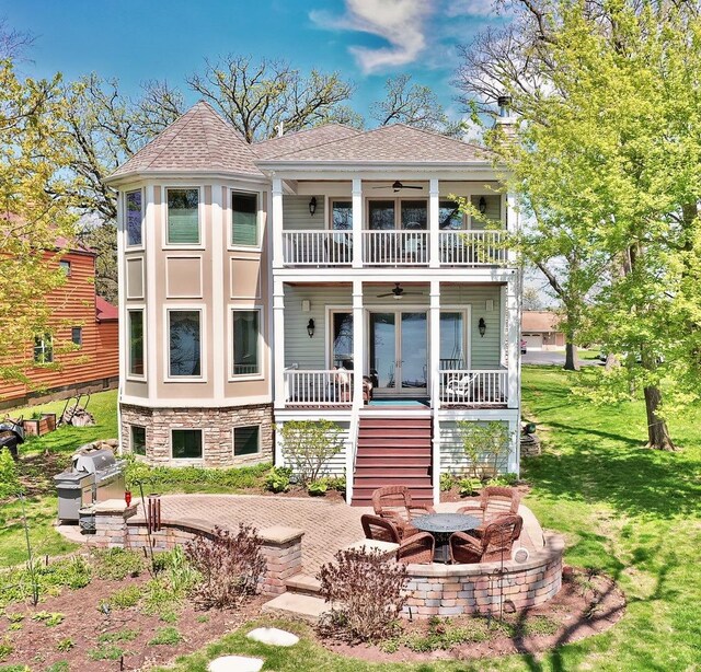 75 N Lake Ave, Third Lake, IL 60030 - rear view of property featuring a balcony, a lawn, a ceiling fan, a fire pit, and a patio area