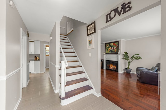 1984 Nottingham Ln, Wheaton, IL 60189 - stairway with a lit fireplace, wood finished floors, and baseboards