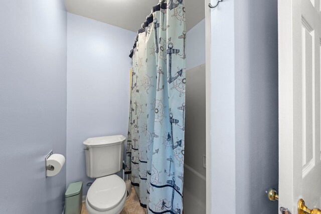 1984 Nottingham Ln, Wheaton, IL 60189 - bathroom featuring toilet, tile patterned floors, and shower / bath combo with shower curtain