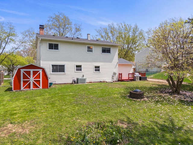 1984 Nottingham Ln, Wheaton, IL 60189 - back of house featuring an outdoor fire pit, a chimney, a storage shed, and an outbuilding