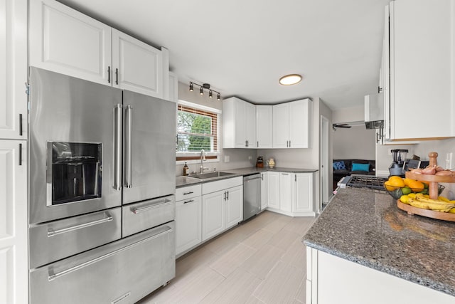 1984 Nottingham Ln, Wheaton, IL 60189 - kitchen featuring appliances with stainless steel finishes, a sink, white cabinets, and dark stone counters