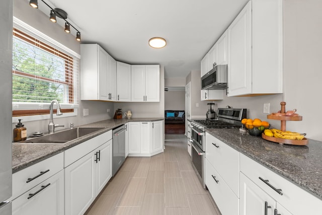 1984 Nottingham Ln, Wheaton, IL 60189 - kitchen with stainless steel appliances, a sink, white cabinetry, and dark stone counters