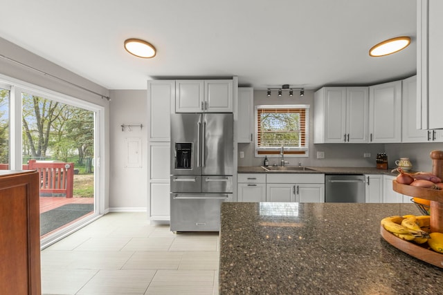 1984 Nottingham Ln, Wheaton, IL 60189 - kitchen with stainless steel appliances, a sink, dark stone counters, and white cabinets